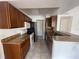 Functional kitchen featuring granite countertops and tile flooring with modern appliances at 1027 S Hiawassee Rd # 2323, Orlando, FL 32835