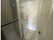 Convenient laundry area includes a washer and additional storage shelving at 1027 S Hiawassee Rd # 2323, Orlando, FL 32835