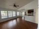 Bright living room with wood floors, ceiling fan, and view to kitchen with counter seating at 1027 S Hiawassee Rd # 2323, Orlando, FL 32835