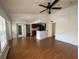 Open-concept living room featuring wood floors, ceiling fan, and view of the kitchen at 1027 S Hiawassee Rd # 2323, Orlando, FL 32835