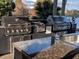 Stainless steel outdoor kitchen with granite countertops, sink and lake views at 1027 S Hiawassee Rd # 2323, Orlando, FL 32835