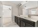 Bathroom with double vanity, decorative lights, and tiled floors at 11843 Fiction Ave, Orlando, FL 32832