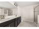 Bathroom featuring a double vanity, glass shower, and modern fixtures at 11843 Fiction Ave, Orlando, FL 32832