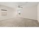 Spacious bedroom with neutral carpet, ceiling fan, and bright windows at 11843 Fiction Ave, Orlando, FL 32832