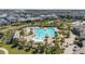 Community pool with lounge chairs and umbrellas surrounded by lush landscaping, creating a relaxing oasis at 11843 Fiction Ave, Orlando, FL 32832