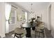 Elegant dining room featuring modern decor, stylish light fixture, and large windows at 11843 Fiction Ave, Orlando, FL 32832