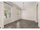 Bright dining room with wood-style tile flooring and modern chandelier at 11843 Fiction Ave, Orlando, FL 32832