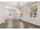 Bright dining room with wood-style tile flooring and modern chandelier at 11843 Fiction Ave, Orlando, FL 32832