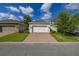Paver driveway leading to a one-car garage at 11843 Fiction Ave, Orlando, FL 32832