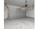 Empty one-car garage with roll up metal door at 11843 Fiction Ave, Orlando, FL 32832