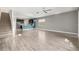 Open-concept living room and kitchen with light-wood floors and natural lighting at 11843 Fiction Ave, Orlando, FL 32832