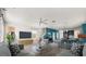 Inviting living room with an open layout connecting the kitchen and dining area, perfect for entertaining at 11843 Fiction Ave, Orlando, FL 32832