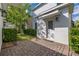 Exterior view of a charming patio with brick pavers and manicured green landscaping at 11843 Fiction Ave, Orlando, FL 32832