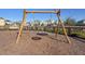Outdoor playground equipment with houses in the background on a sunny day at 11843 Fiction Ave, Orlando, FL 32832