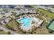 An aerial view of a resort-style pool featuring ample seating, palm trees, and a playground nearby at 11843 Fiction Ave, Orlando, FL 32832