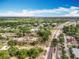 Aerial view of community featuring well-maintained buildings, parking, lush landscaping, and nearby access roads at 12539 Orangewood Ct, Tavares, FL 32778