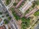 Aerial view of a property with parking and landscaping next to a multi-lane road at 12539 Orangewood Ct, Tavares, FL 32778