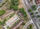 Aerial view of a property with parking and landscaping next to a multi-lane road at 12539 Orangewood Ct, Tavares, FL 32778