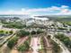 Expansive aerial view of waterfront homes, serene lake, and lush greenery in a vibrant, thriving community at 12539 Orangewood Ct, Tavares, FL 32778