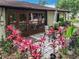 Back patio with pavers and outdoor seating area surrounded by beautiful landscaping at 12539 Orangewood Ct, Tavares, FL 32778
