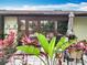Cozy backyard patio with lush tropical plants and outdoor seating area at 12539 Orangewood Ct, Tavares, FL 32778