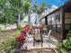 Landscaped backyard with patio dining set and large mature trees at 12539 Orangewood Ct, Tavares, FL 32778