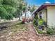 Backyard with a view of a patio area with outdoor furniture and lush landscaping around the house at 12539 Orangewood Ct, Tavares, FL 32778