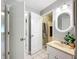 Well-lit bathroom featuring a vanity with an oval mirror and an open doorway to the shower at 12539 Orangewood Ct, Tavares, FL 32778