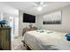 Bedroom with tile floors, ceiling fan, a television on the wall, and access to the bathroom at 12539 Orangewood Ct, Tavares, FL 32778