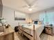 Comfortable bedroom featuring a decorative metal bed frame, soft lighting, and a serene atmosphere at 12539 Orangewood Ct, Tavares, FL 32778
