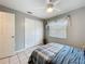Cozy bedroom featuring neutral tones, ceiling fan, window with blinds, and a double-door closet at 12539 Orangewood Ct, Tavares, FL 32778