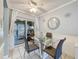 Bright dining area with glass table, seating for four, and sliding door to outdoor patio at 12539 Orangewood Ct, Tavares, FL 32778