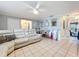 Comfortable living room with tile floors, a white leather sectional, and stylish decor at 12539 Orangewood Ct, Tavares, FL 32778