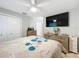 Comfortable main bedroom with a ceiling fan, TV, and wooden dressers at 12539 Orangewood Ct, Tavares, FL 32778