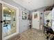 Coastal themed sunroom featuring tiled floors, bright lighting, and sliding glass door to home's interior at 12539 Orangewood Ct, Tavares, FL 32778