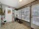 Sunroom with lots of windows, a door, and unique flooring at 12539 Orangewood Ct, Tavares, FL 32778