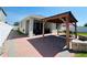 Backyard features a covered patio, brick pavers, and a well-maintained lawn at 1321 Yorkdale Rd, Davenport, FL 33837