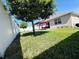 Well-maintained backyard with a privacy fence, covered patio, and grassy area at 1321 Yorkdale Rd, Davenport, FL 33837