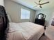 Bedroom showcasing a large bed, ceiling fan, and a dark wood dresser at 1321 Yorkdale Rd, Davenport, FL 33837