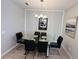 This formal dining room features stylish wall trim, a glass table, and seating for six at 1321 Yorkdale Rd, Davenport, FL 33837