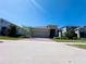 Inviting home with a two-car garage, manicured lawn, and a brick driveway at 1321 Yorkdale Rd, Davenport, FL 33837