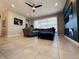 A comfortable living room with a ceiling fan and an electric fireplace under the television at 1321 Yorkdale Rd, Davenport, FL 33837