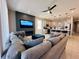 Spacious living room with a large sectional couch and an electric fireplace below the television at 1321 Yorkdale Rd, Davenport, FL 33837