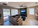 The cozy living room features an electric fireplace under the television and a large sliding glass door at 1321 Yorkdale Rd, Davenport, FL 33837