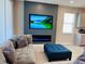 This living room features an electric fireplace below the television and a comfortable sectional couch at 1321 Yorkdale Rd, Davenport, FL 33837