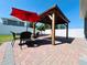 An outdoor patio features a gazebo, red umbrella, and a table with four chairs at 1321 Yorkdale Rd, Davenport, FL 33837