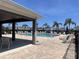 A community pool with lots of chairs and a covered area with palm trees in the background at 1321 Yorkdale Rd, Davenport, FL 33837