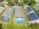 An aerial view of a backyard with a screened-in pool and lush green landscaping at 1338 Lake Biscayne Way, Orlando, FL 32824