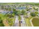 An aerial view of a neighborhood featuring lush trees, gated entrances and shimmering lakes at 1338 Lake Biscayne Way, Orlando, FL 32824