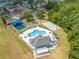 An aerial view showcases the neighborhood pool, playground, and basketball court near residences at 1338 Lake Biscayne Way, Orlando, FL 32824
